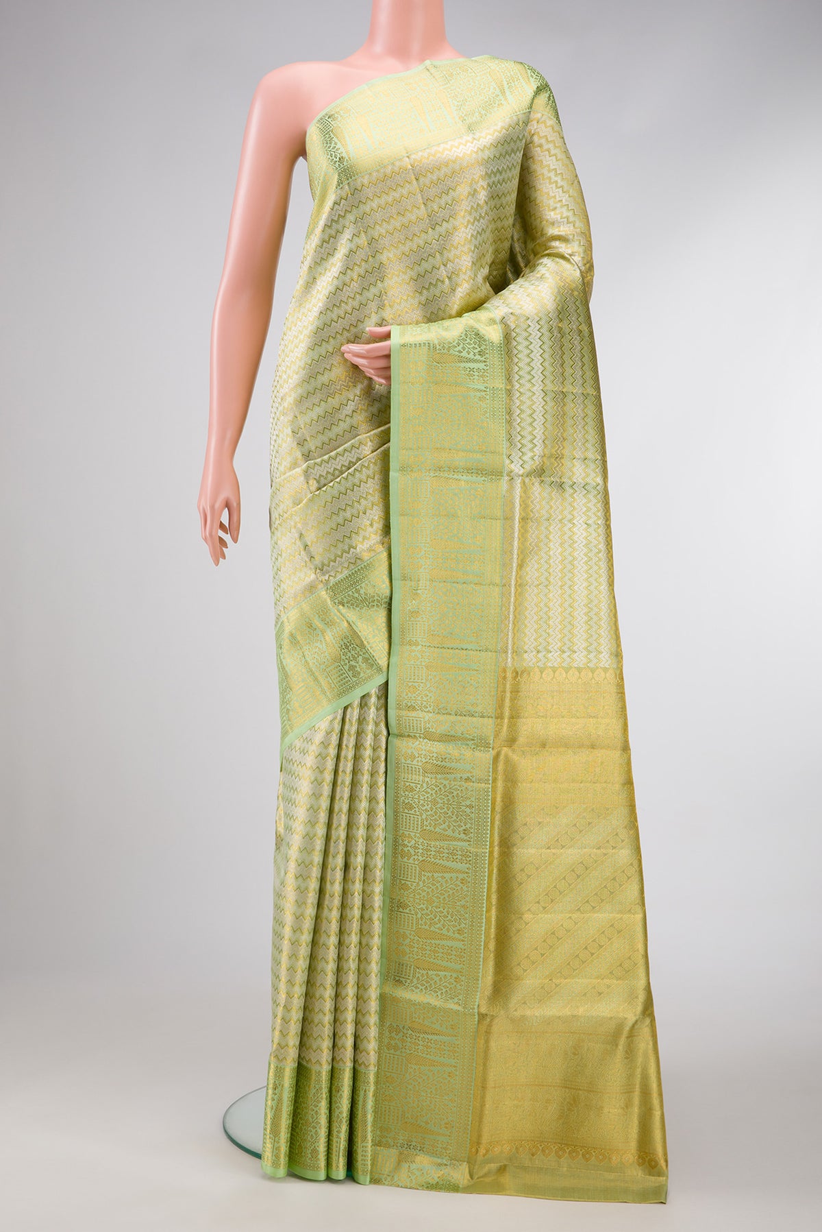 Pista Green Dual Tone Kanjivaram Tissue Silk Saree with Zari Brocade on the body and Zari Border.  displayed on a mannequin