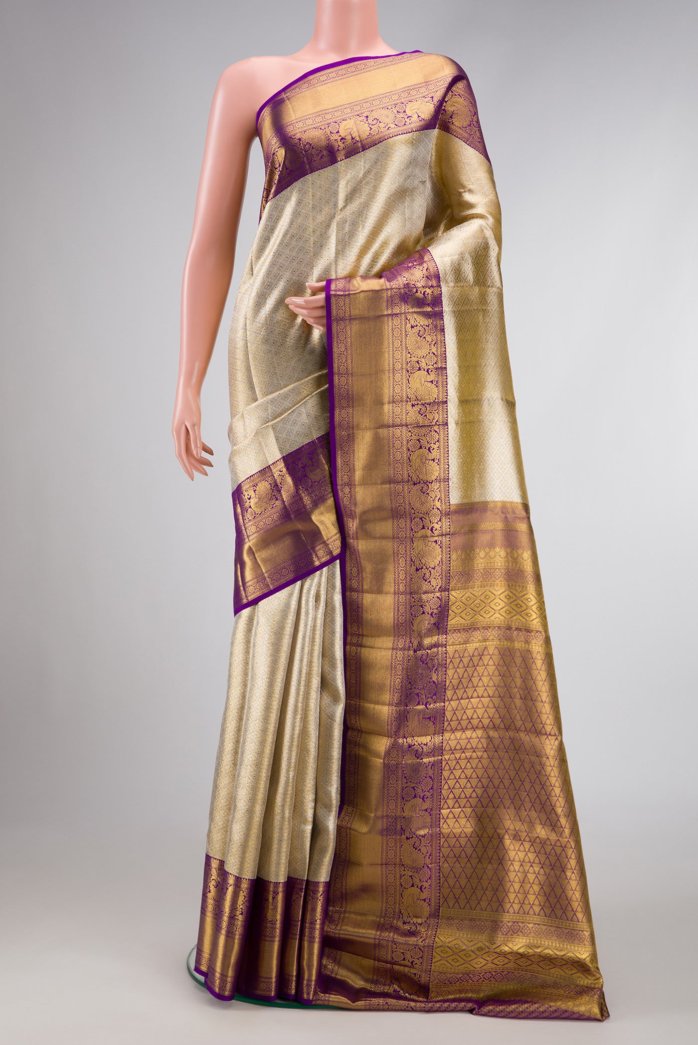 Gold Dual Tone Kanjivaram Tissue Silk Saree with Zari Brocade on the body and Zari Border.  displayed on a mannequin