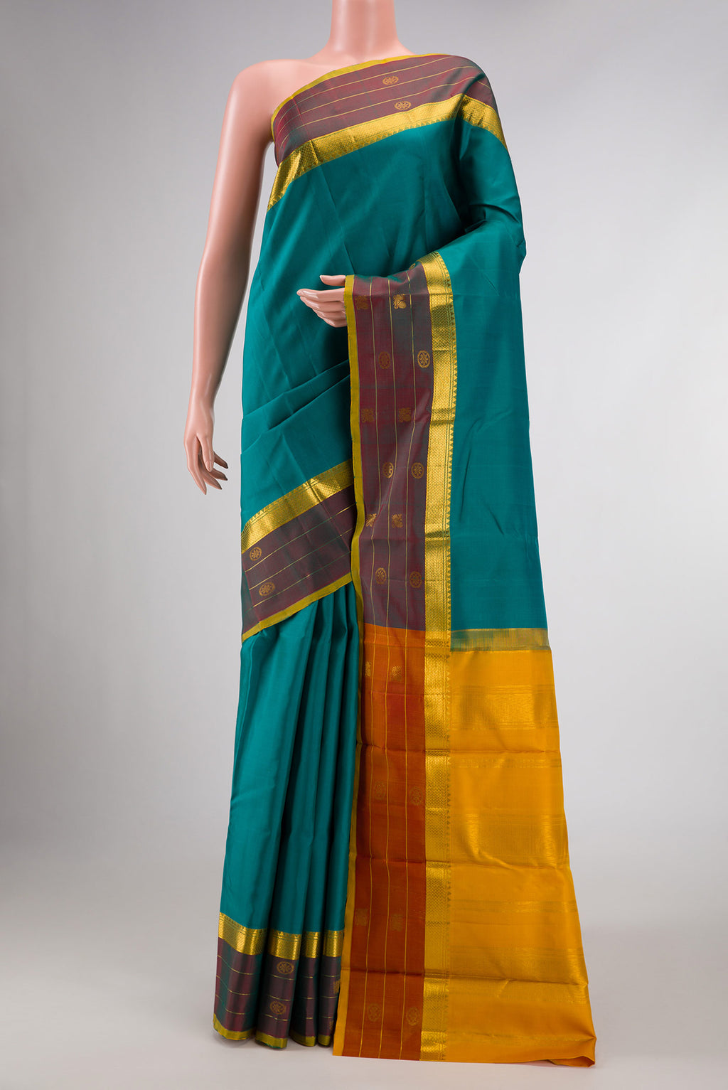 Pure Silk Pure Zari Green Dual Tone Kanchipuram Saree with Plain Body and Zari Border displayed on a mannequin