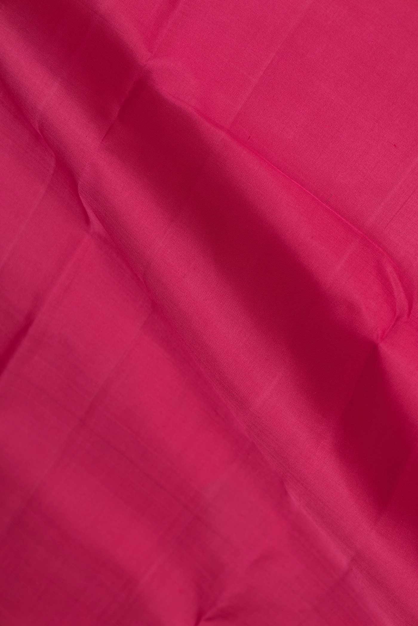 Close up of Pink Dual Tone Kanchipuram Silk Saree with Plain Body and Zari Border displaying folds