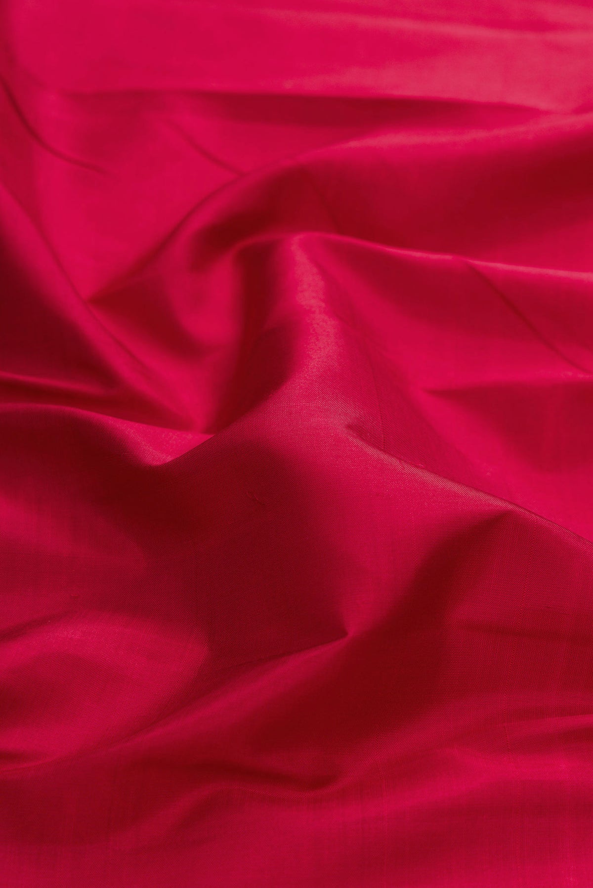 Close up of Maroon Dual Tone Kanchipuram Silk Saree with Plain Body and Zari Border displaying folds