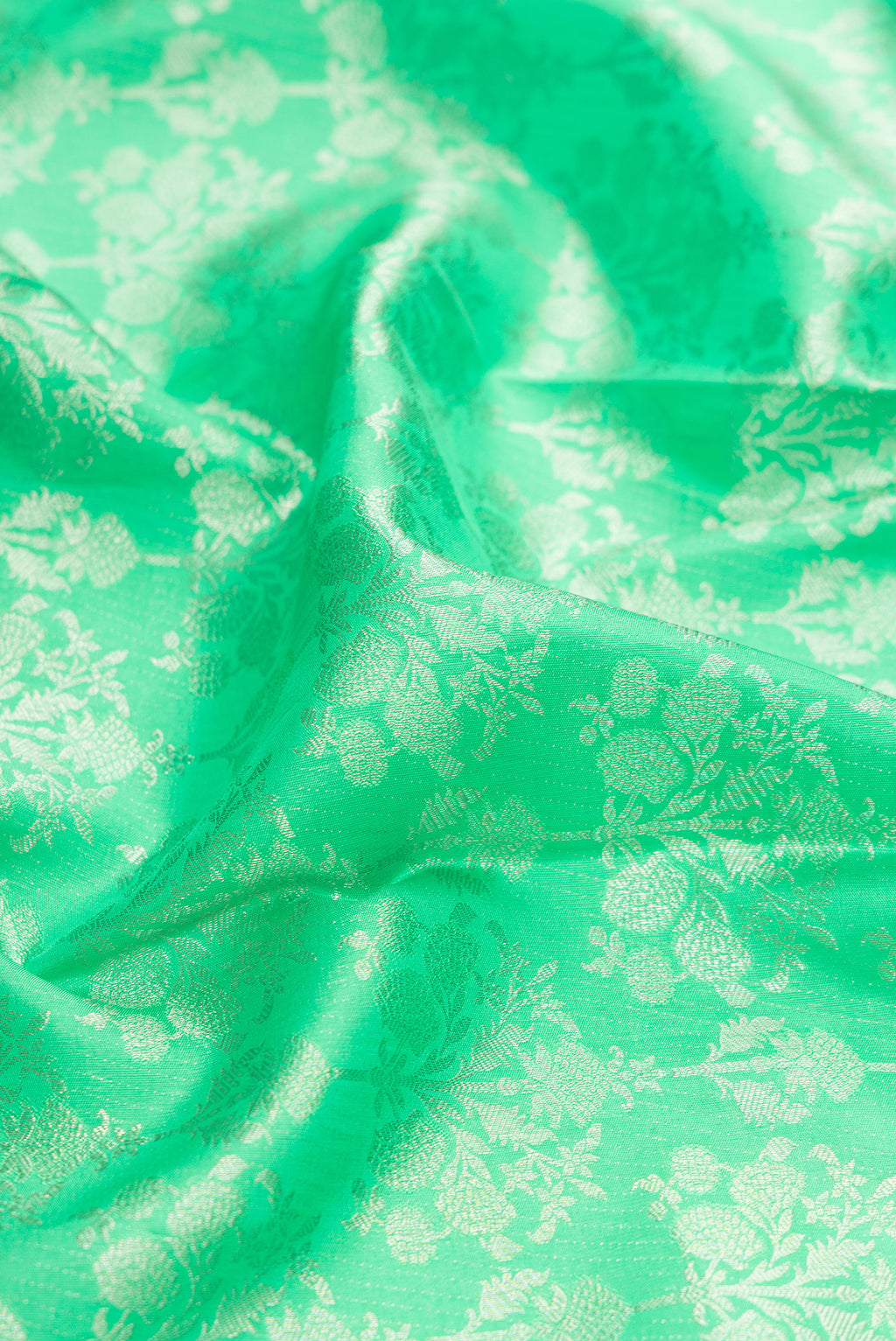 Close up of Parrot Green Dual Tone Kanjivaram Silk Saree with Zari Brocade on the body and Zari Border.  displaying folds