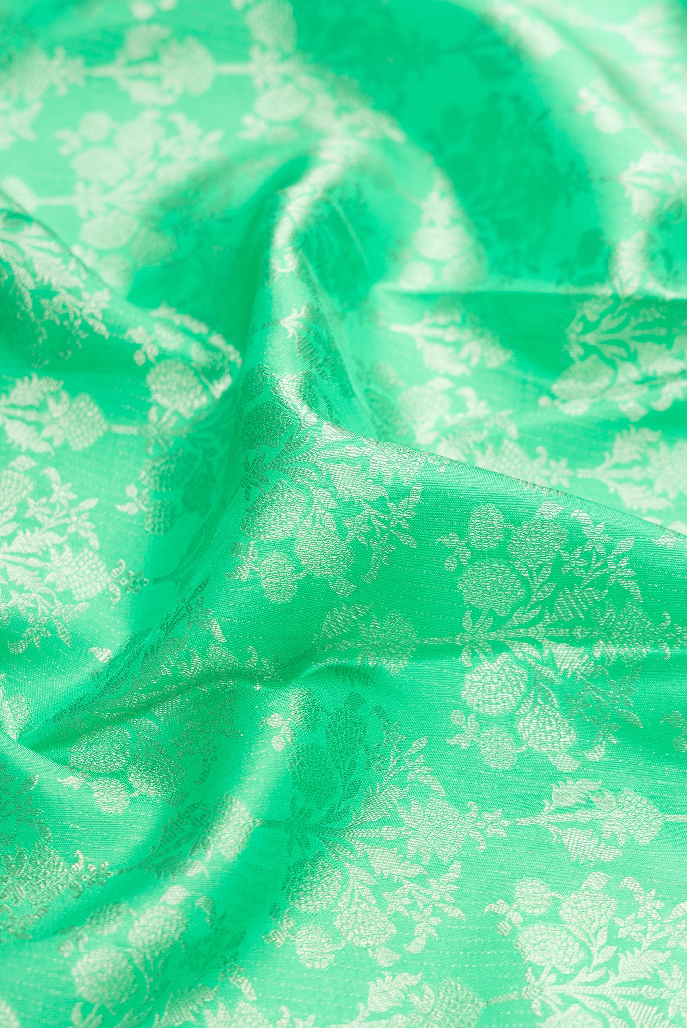 Close up of Parrot Green Dual Tone Kanjivaram Silk Saree with Zari Brocade on the body and Zari Border.  displaying folds