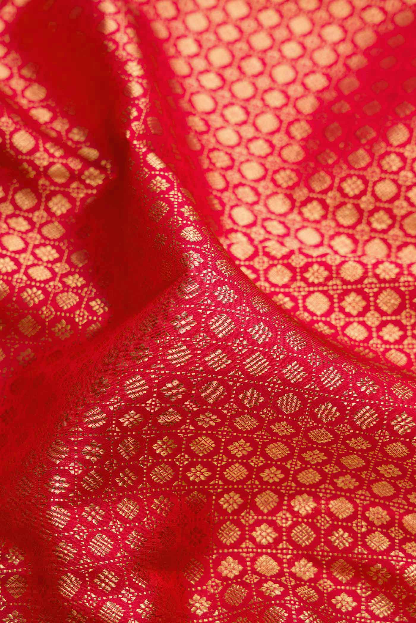 Close up of Maroon Dual Tone Kanjivaram Silk Saree with Zari Brocade on the body and Zari Border.  displaying folds
