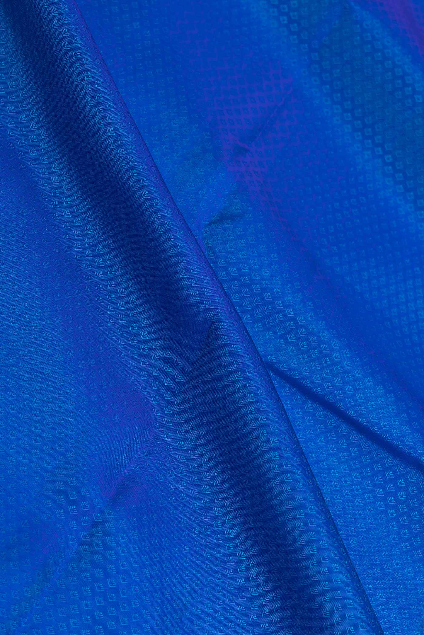 Close up of Peacock Blue Dual Tone Kanchipuram Saree with Jacquard design on the body and Zari Border displaying folds