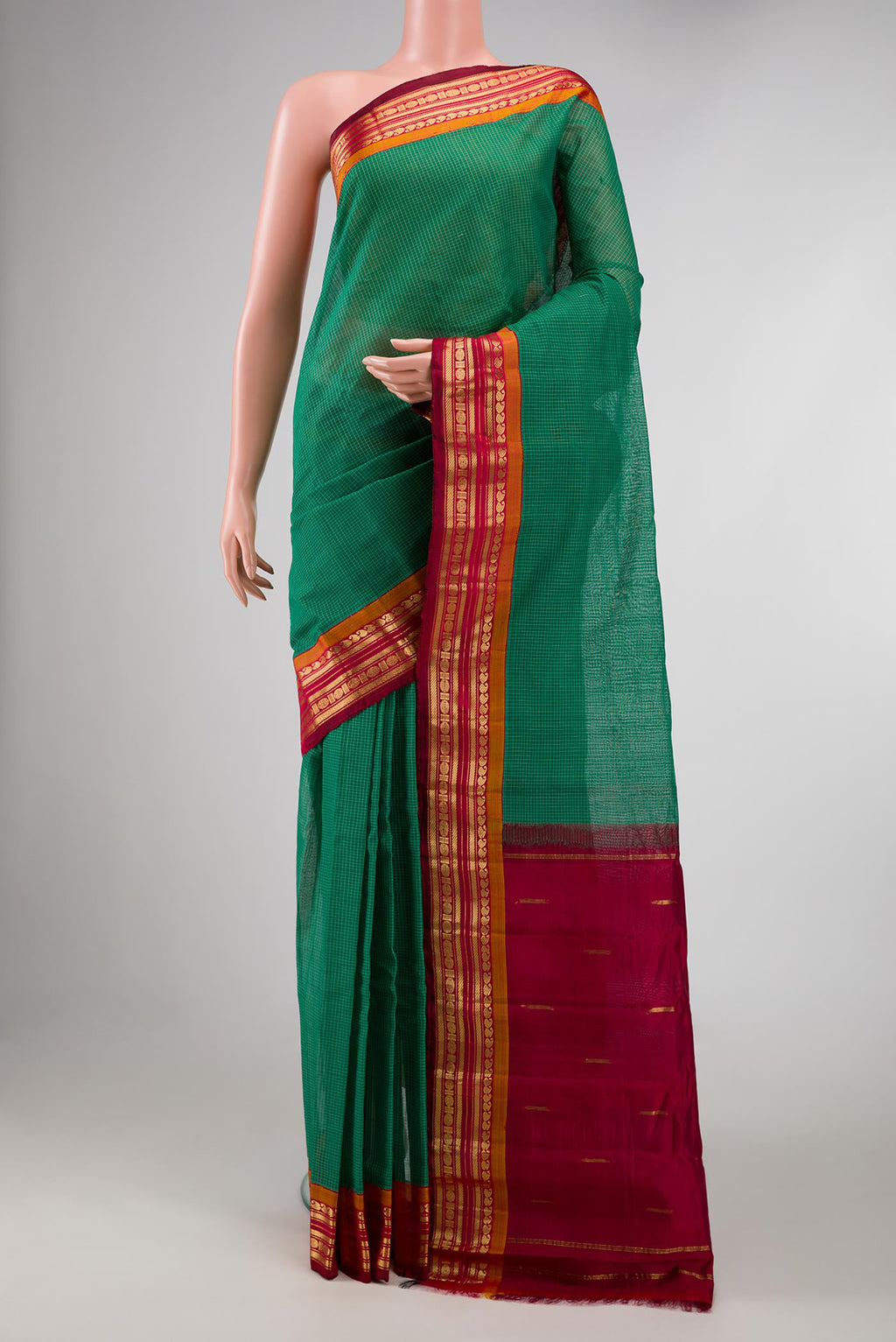 Green Gadwal cotton Saree with Checked design on the body and Zari Border displayed on a mannequin