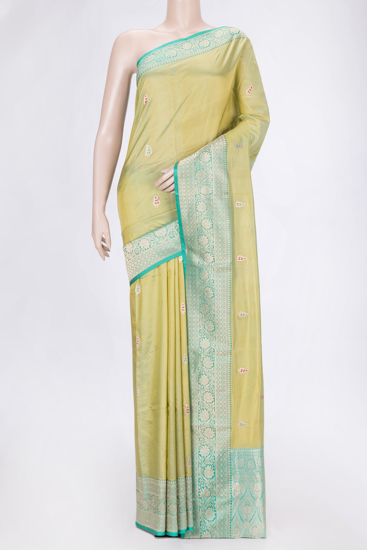 Pista Green Dual Tone Banarasi Silk Saree with Zari And Thread Butta on the body and Zari Border.  displayed on a mannequin
