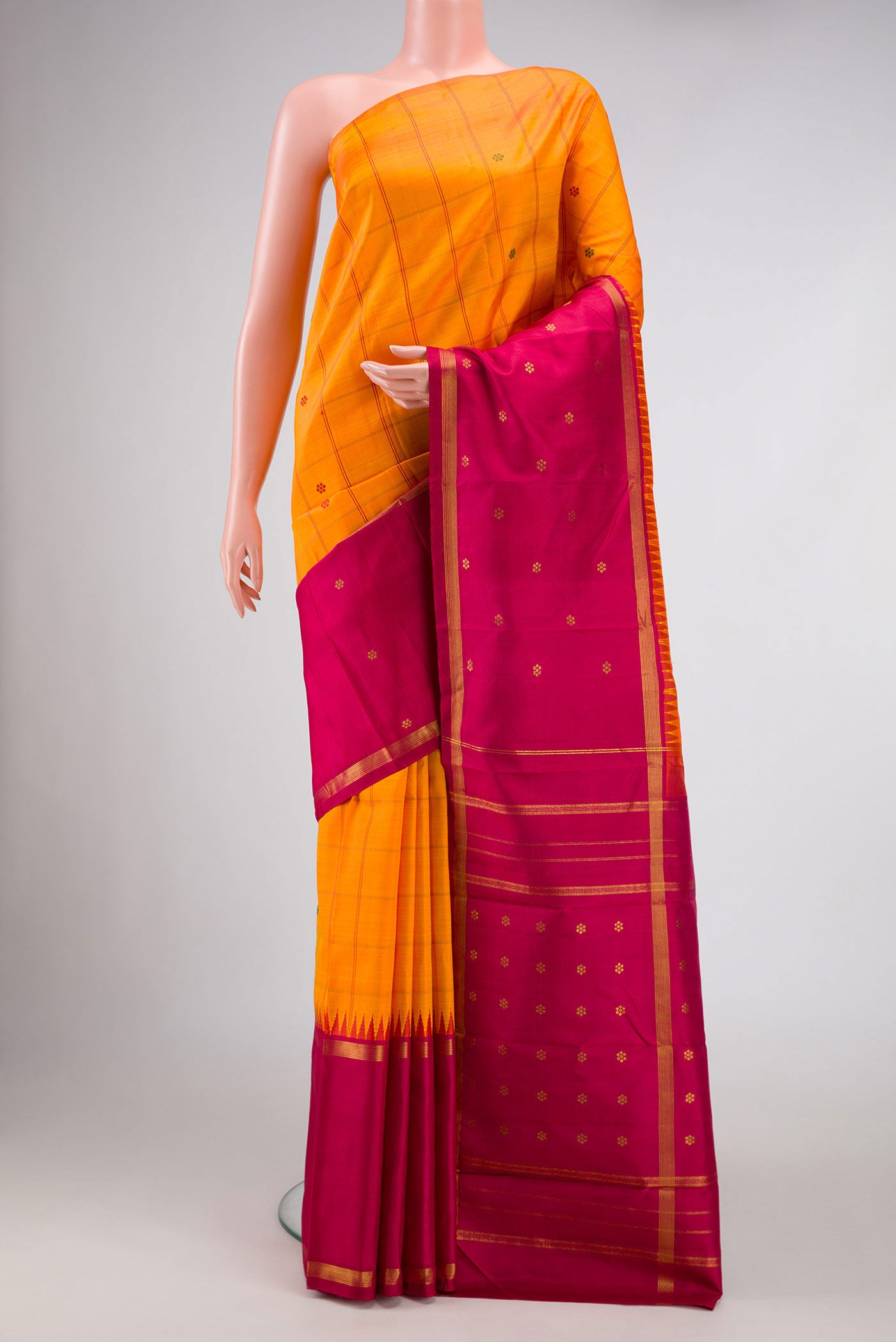Orange Dual Tone Kanchipuram Silk Saree with Checked design on the body and Zari Border displayed on a mannequin