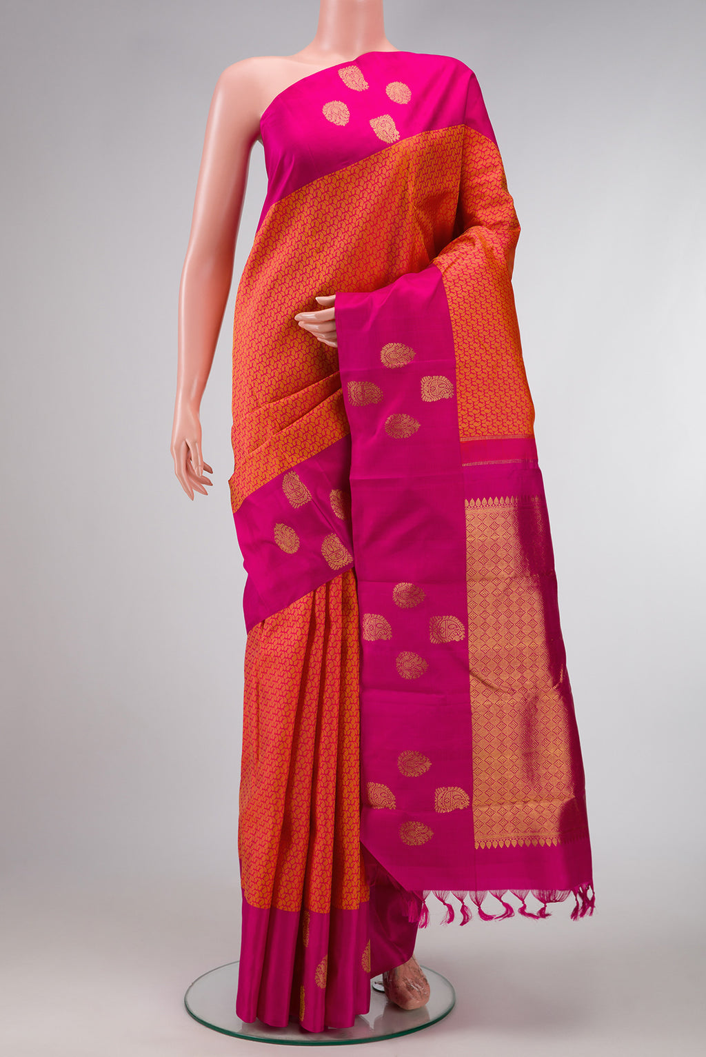 Coral Dual Tone Kanjivaram Silk Saree with Jacquard design on the body and Fancy Border.  displayed on a mannequin