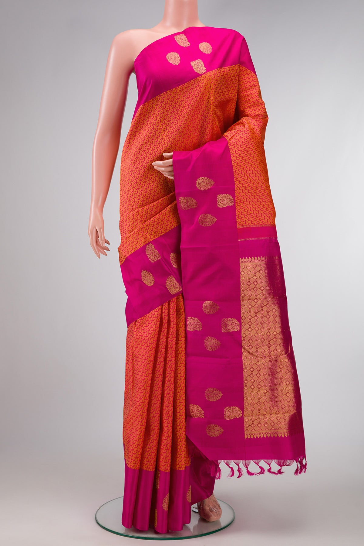 Coral Dual Tone Kanjivaram Silk Saree with Jacquard design on the body and Fancy Border.  displayed on a mannequin