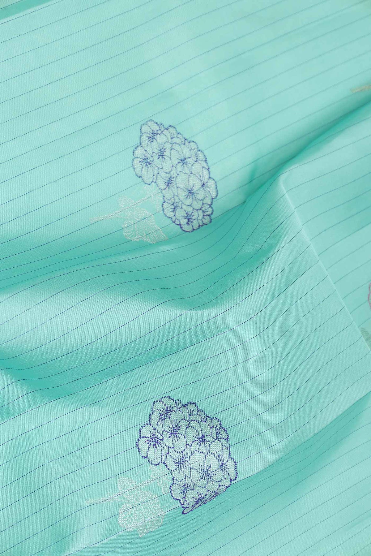 Close up of Pure Silk Pure Zari Sea Green Dual Tone Kanchipuram Saree with Zari Butta on the body and Without Border displaying folds