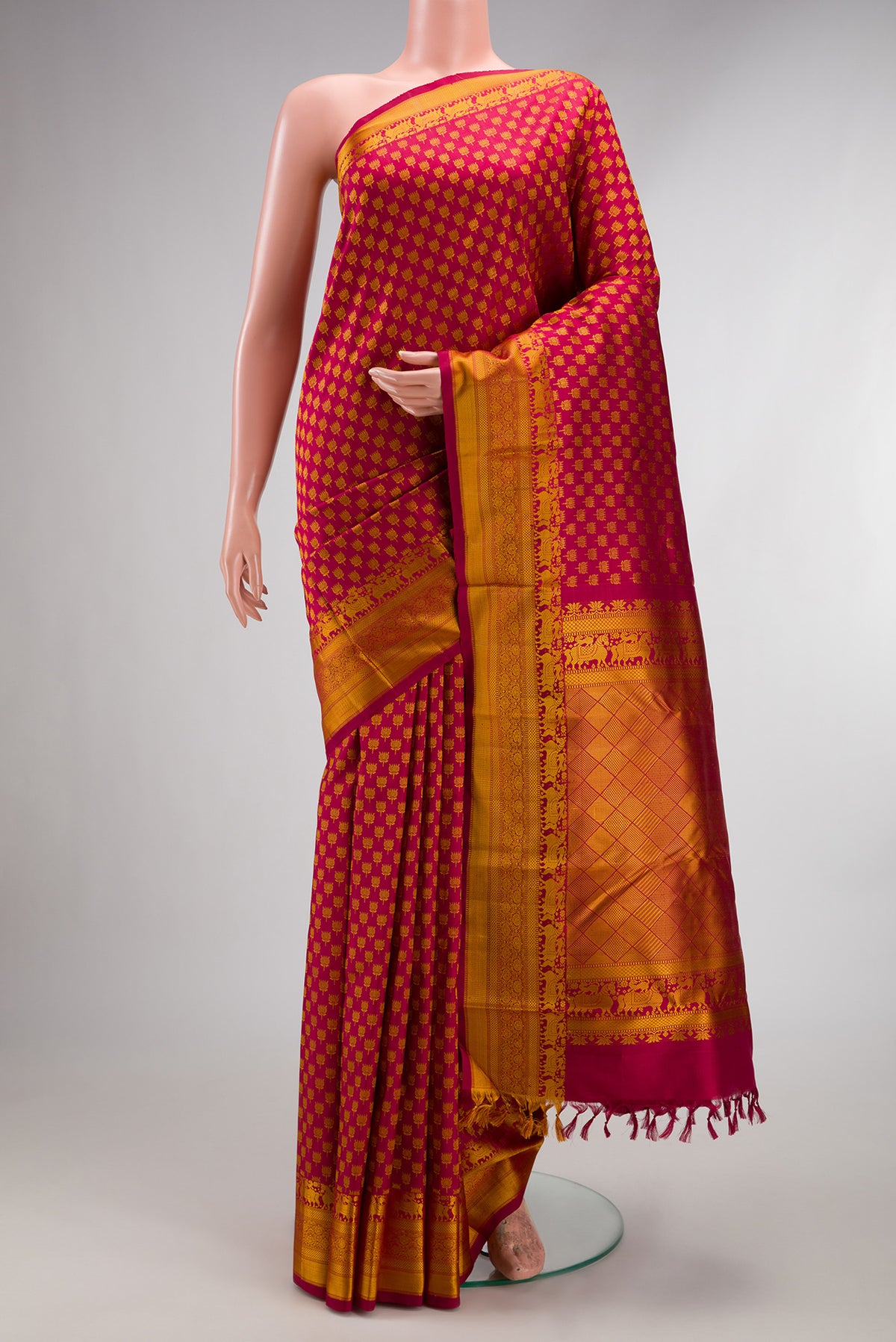 Pure Silk Maroon Kanjivaram Saree with Thread Brocade on the body and Thread Border.  displayed on a mannequin