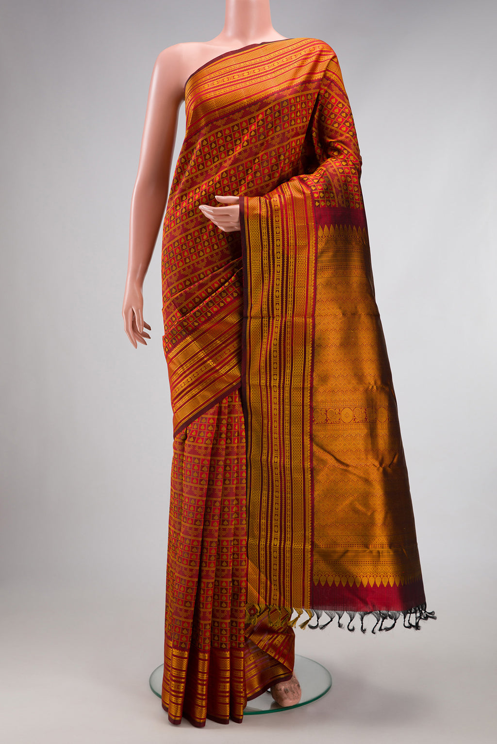 Maroon Kanjivaram Silk Saree with Jacquard design on the body and Thread Border.  displayed on a mannequin