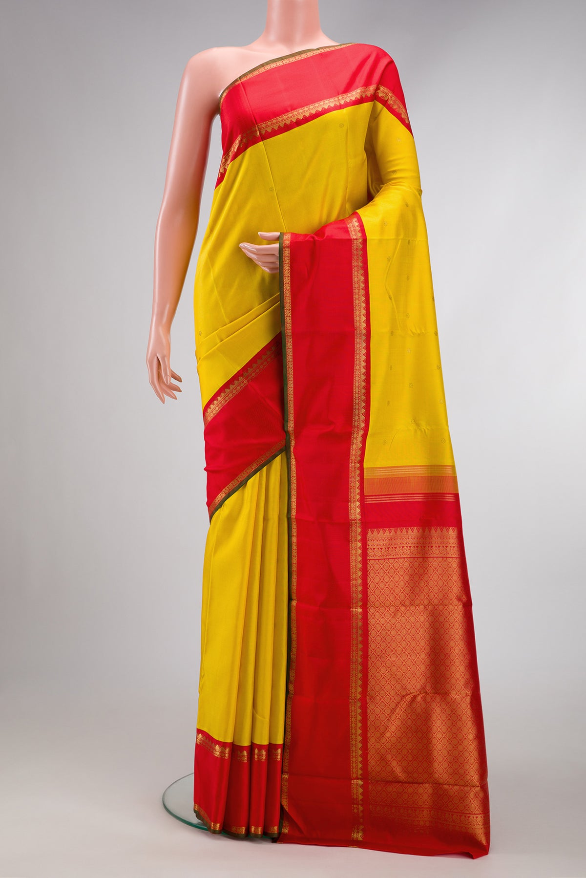 Yellow Dual Tone Kanjivaram Silk Saree with Zari Butta on the body and Zari Border.  displayed on a mannequin