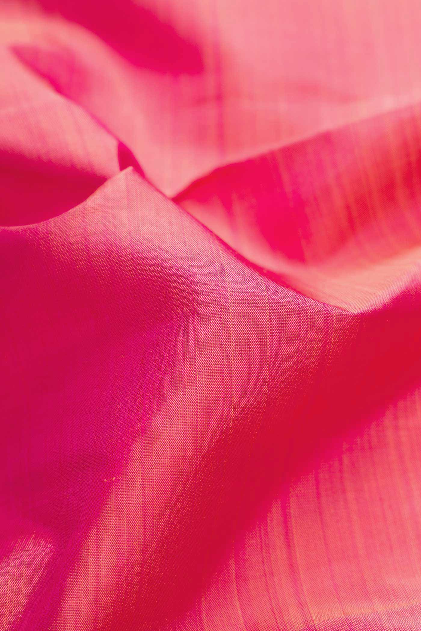 Close up of Pure Silk Pure Zari Pink Dual Tone Kanchipuram Saree with Plain Body and Zari Border displaying folds