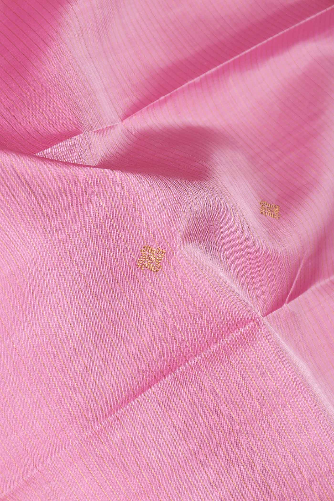 Close up of Pure Silk Pure Zari Pink Dual Tone Kanchipuram Saree with Zari Butta on the body and Zari Border displaying folds