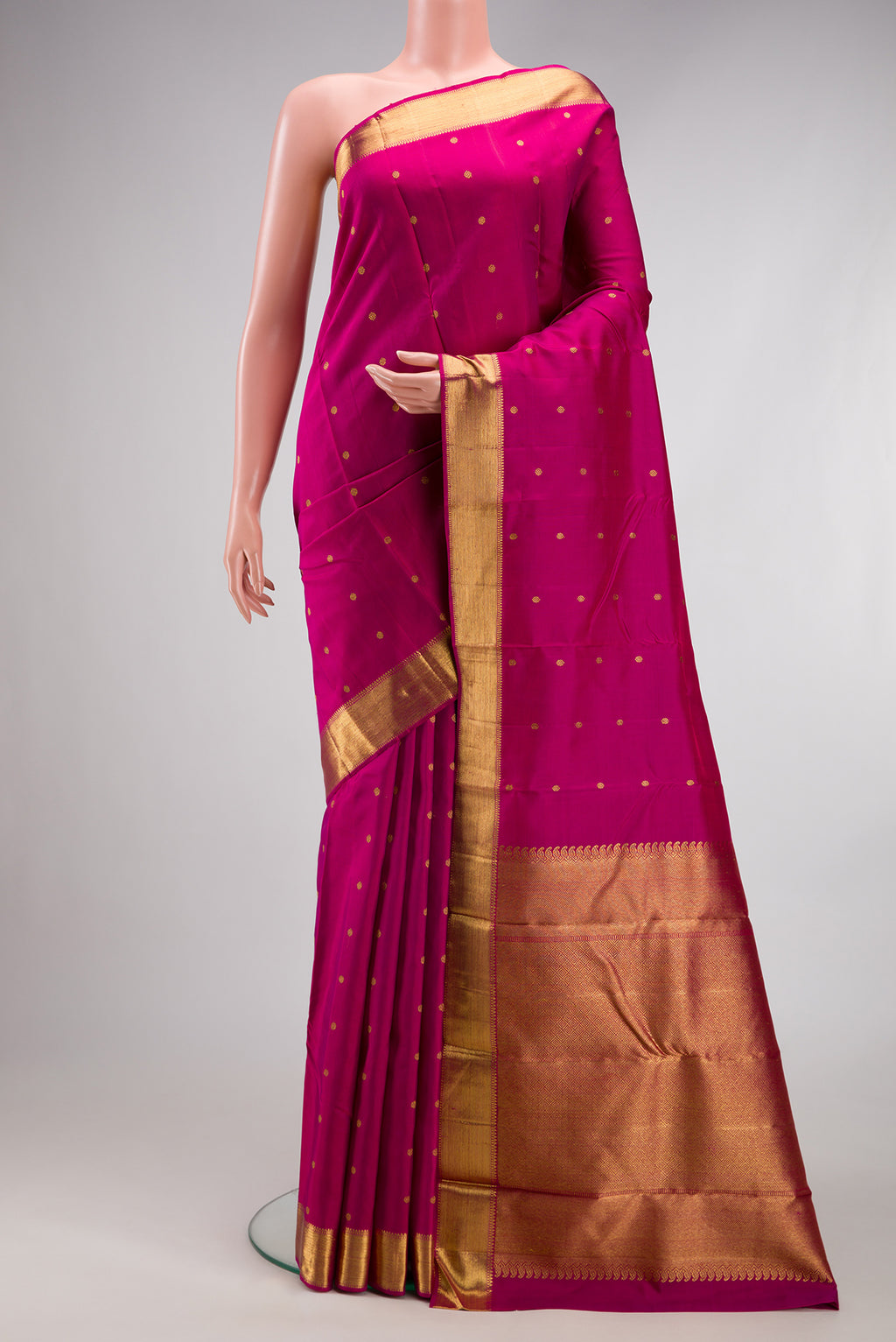 Pure Silk Pure Zari Magenta Kanjivaram Saree with Zari Butta on the body and Zari Border.  displayed on a mannequin