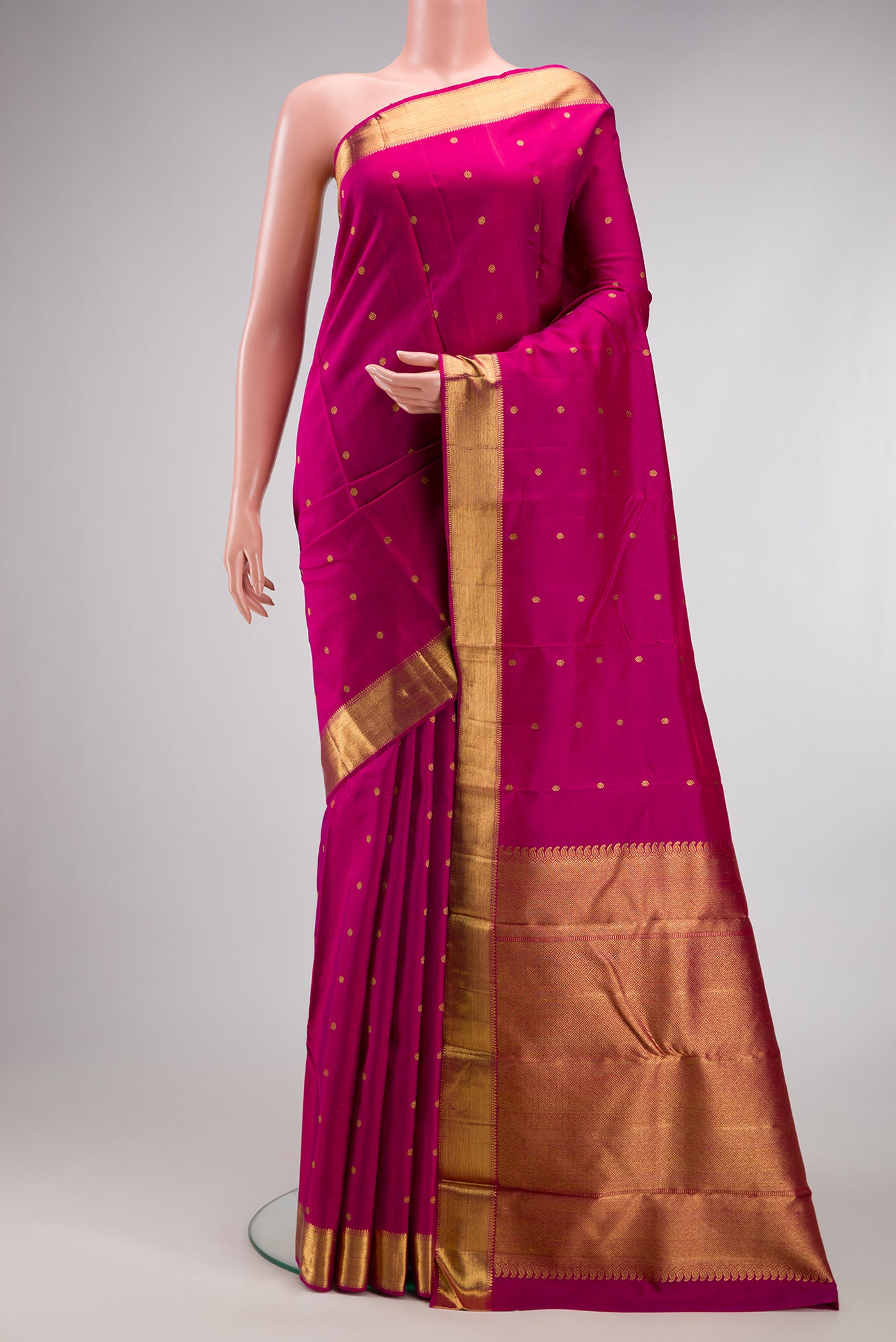 Pure Silk Pure Zari Magenta Kanjivaram Saree with Zari Butta on the body and Zari Border.  displayed on a mannequin