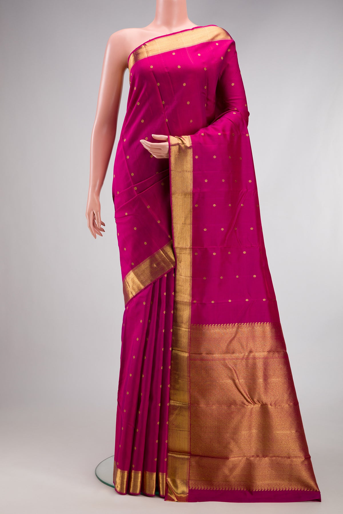 Pure Silk Pure Zari Magenta Kanjivaram Saree with Zari Butta on the body and Zari Border.  displayed on a mannequin