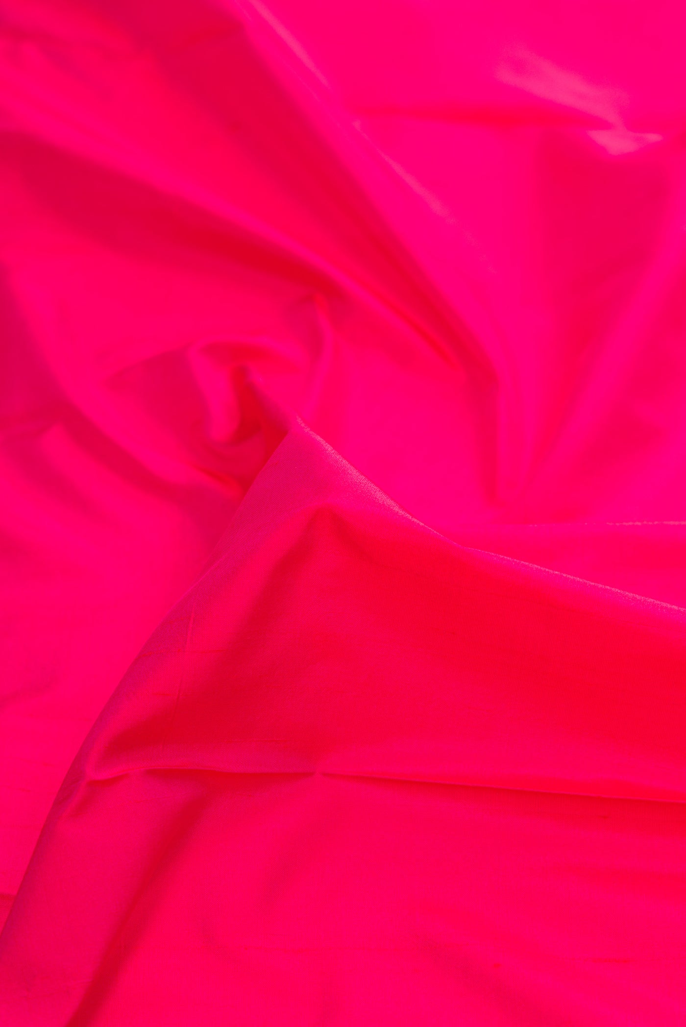 Close up of Pink Dual Tone Kanchipuram Silk Saree with Plain Body and Zari Border.  displaying folds