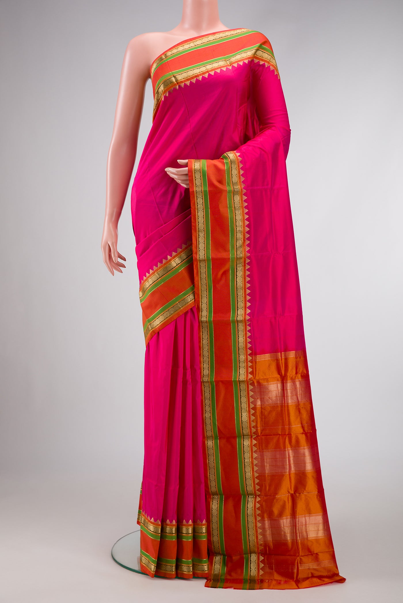 Pink Dual Tone Kanchipuram Silk Saree with Plain Body and Zari Border.  displayed on a mannequin