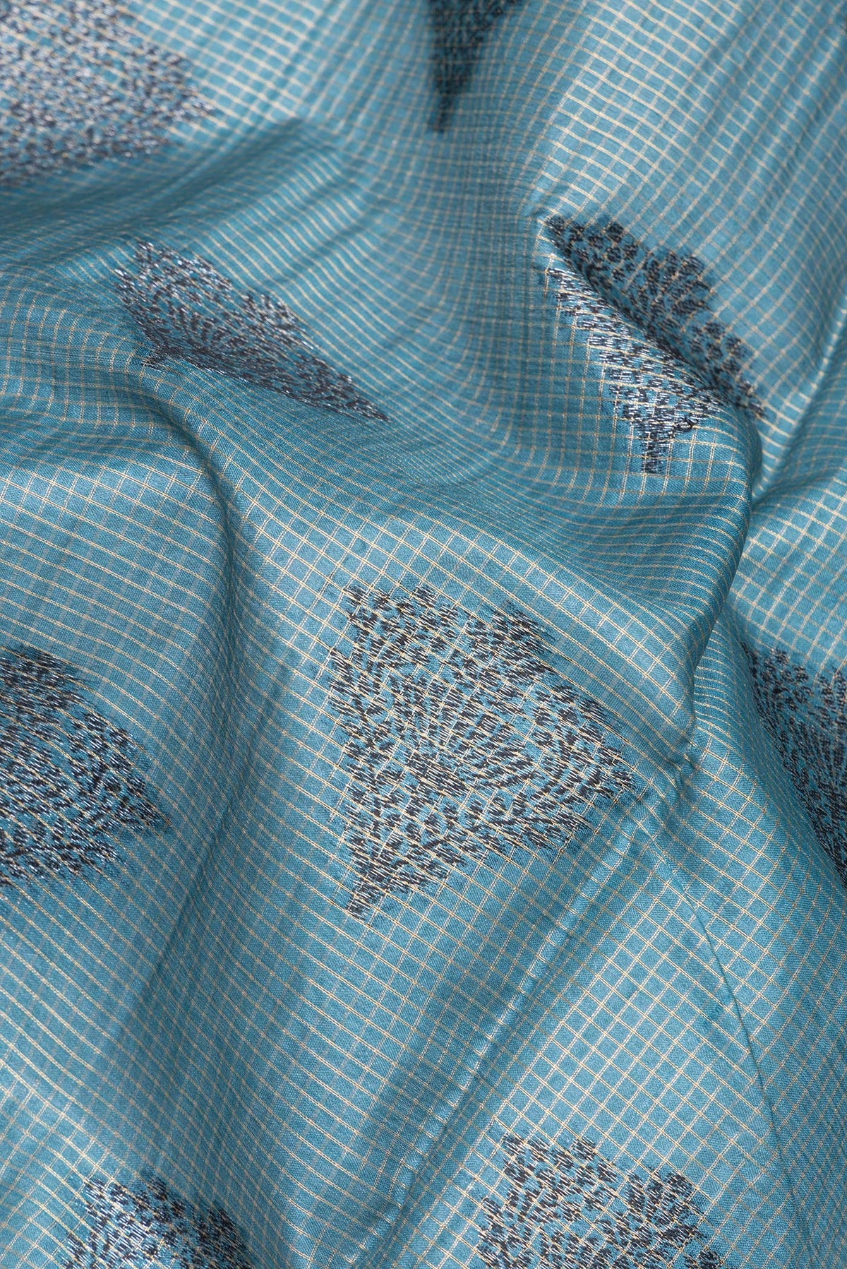Close up of Grey Tussar Silk Saree with Checked design on the body and Zari Border.  displaying folds