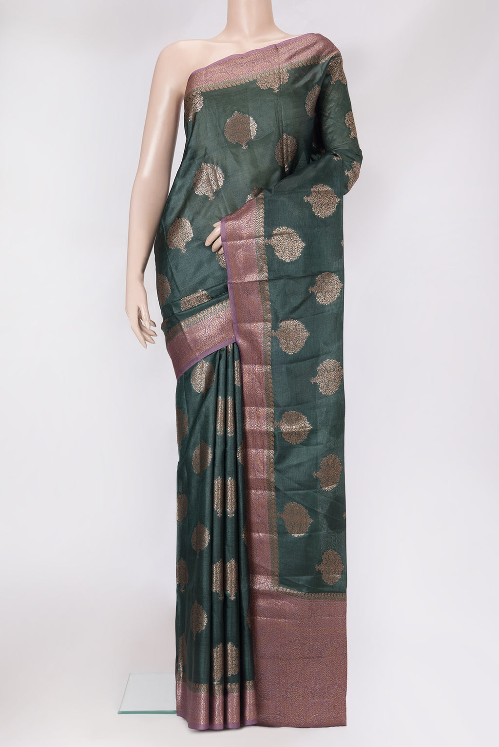 Bottle Green Banarasi Tussar Silk Saree with Zari Butta on the body and Zari Border.  displayed on a mannequin