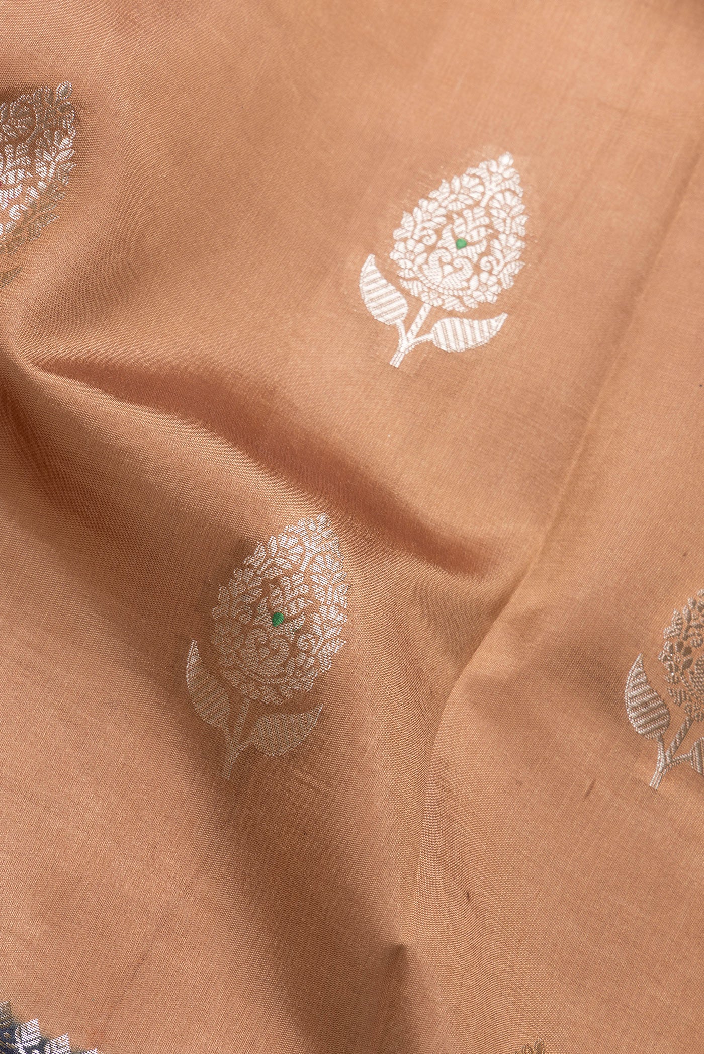 Close up of Brown Dual Tone Tussar Silk Saree with Zari Butta on the body and Fancy Border.  displaying folds