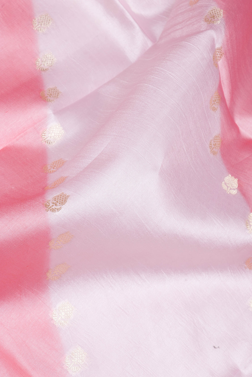 Close up of Rose pink Banarasi Raw Silk Saree with Zari Butta on the body and Fancy Border.  displaying folds