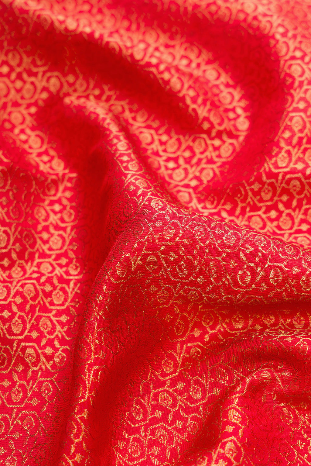 Close up of Pure Silk Pure Zari Red Dual Tone Kanjivaram Saree with Zari Brocade on the body and Zari Border.  displaying folds