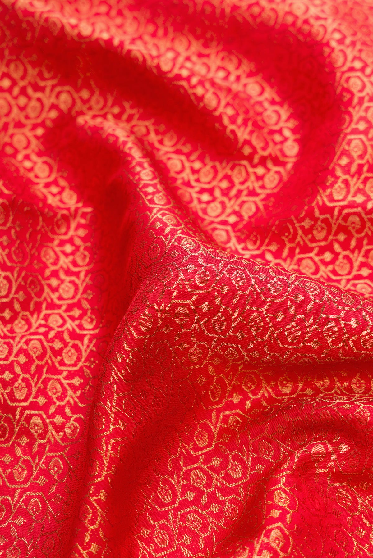 Close up of Pure Silk Pure Zari Red Dual Tone Kanjivaram Saree with Zari Brocade on the body and Zari Border.  displaying folds