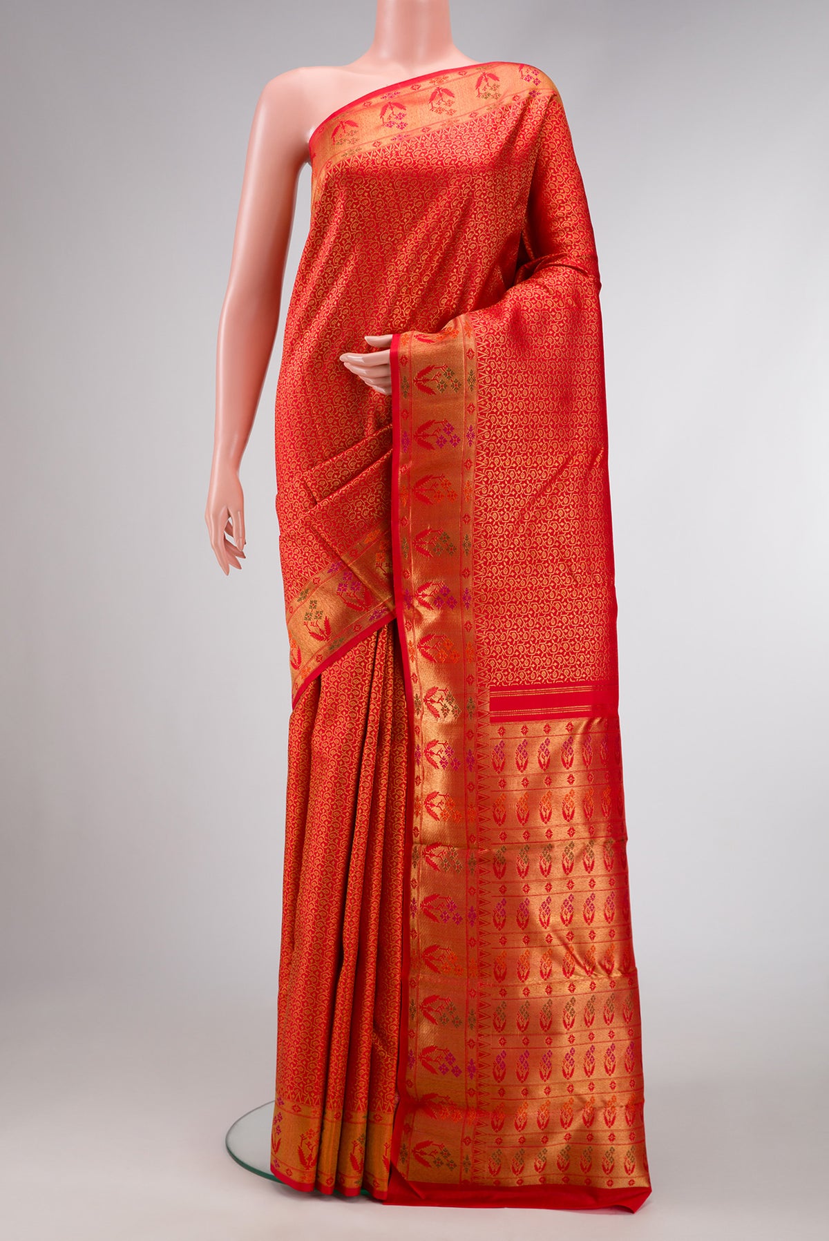 Pure Silk Pure Zari Red Dual Tone Kanjivaram Saree with Zari Brocade on the body and Zari Border.  displayed on a mannequin