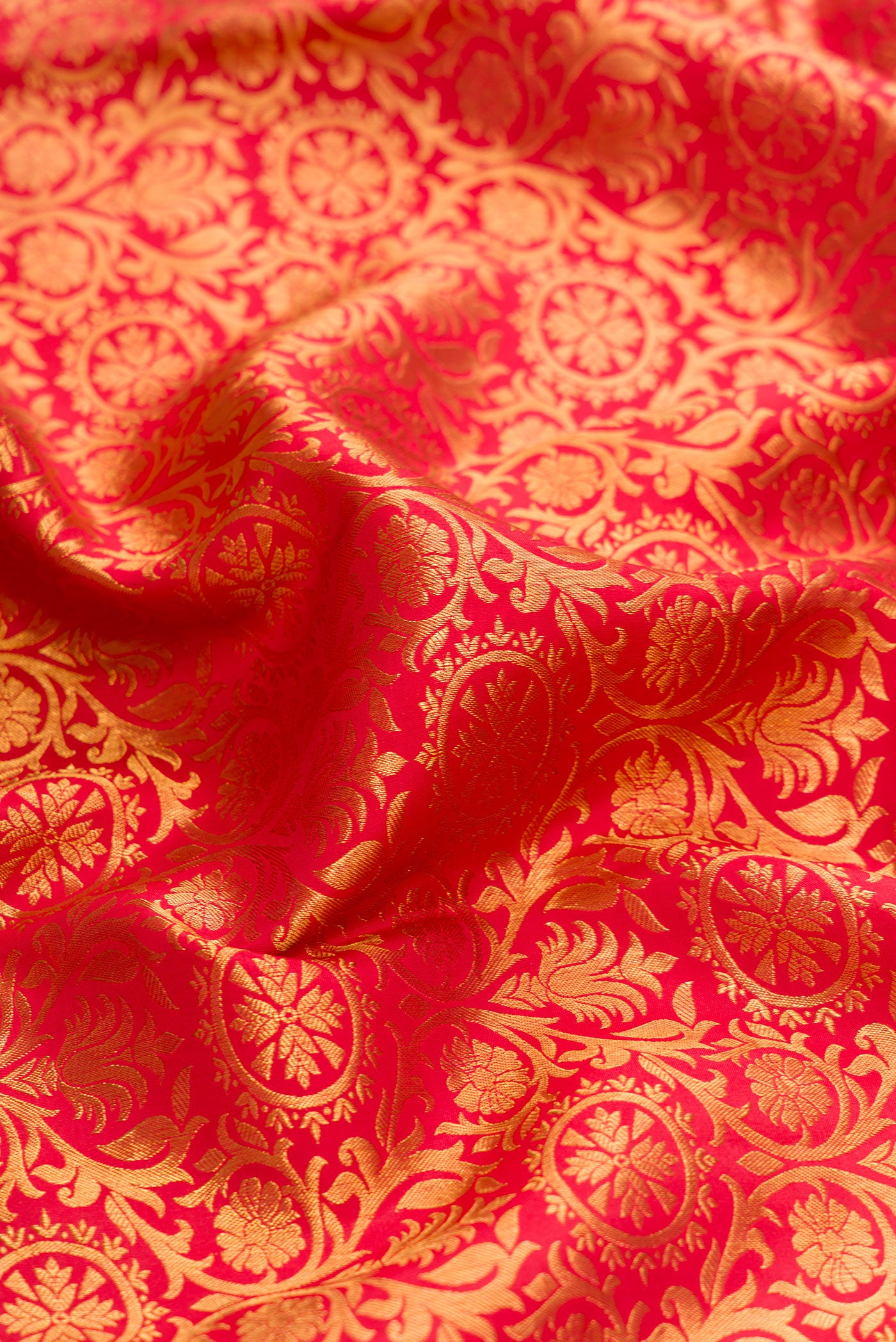 Close up of Red Dual Tone Kanjivaram Silk Saree with Zari Brocade on the body and Zari Border.  displaying folds
