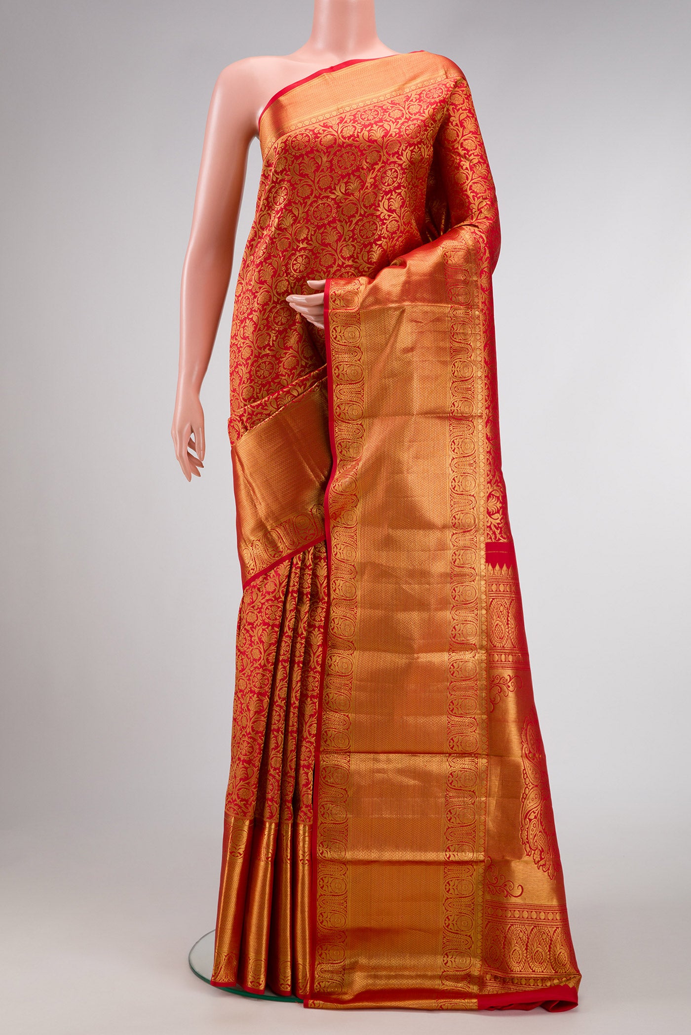 Red Dual Tone Kanjivaram Silk Saree with Zari Brocade on the body and Zari Border.  displayed on a mannequin