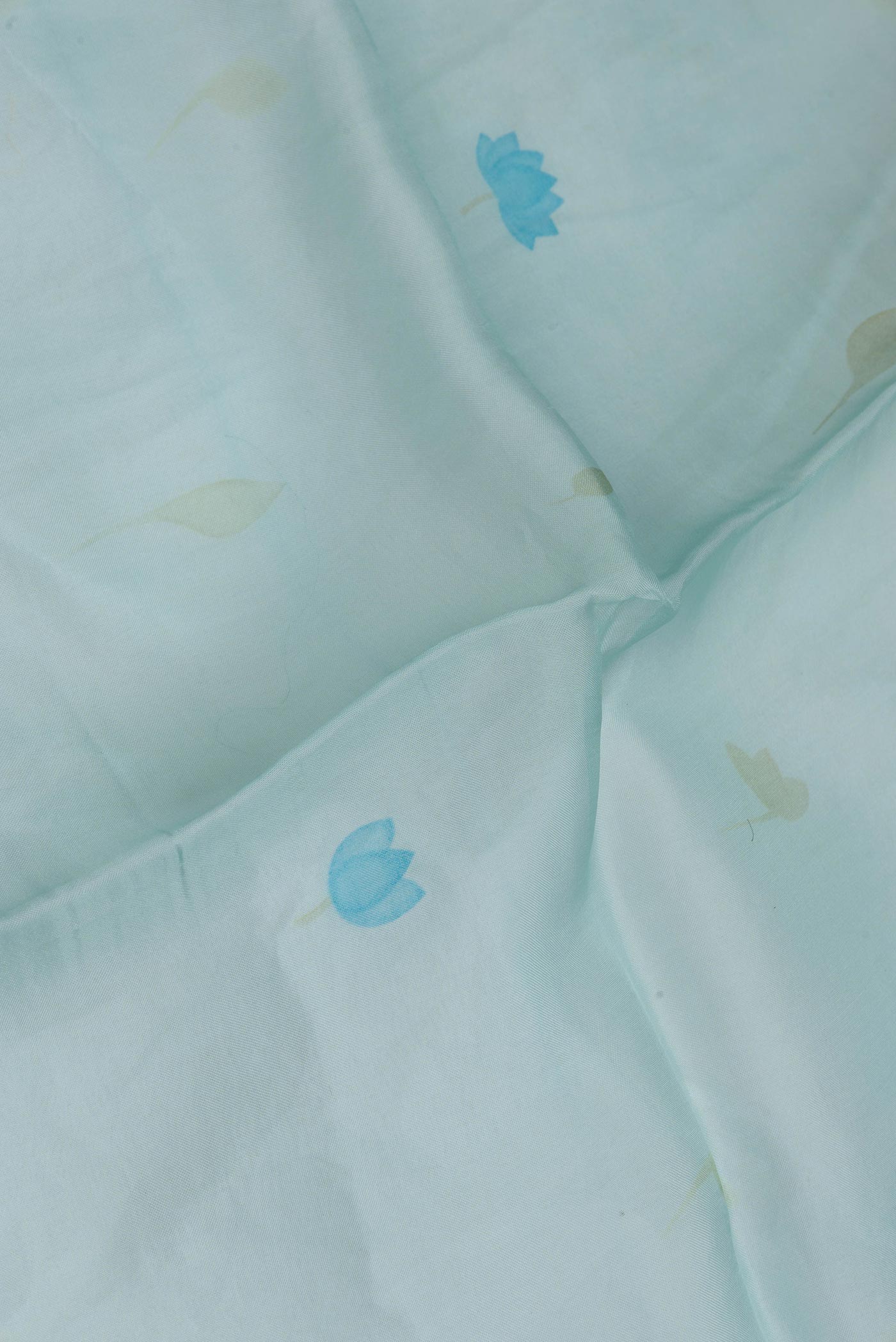 Close up of Light Blue Dual Tone Organza Silk Saree with Embroidery on the body and Embroidery Border.  displaying folds