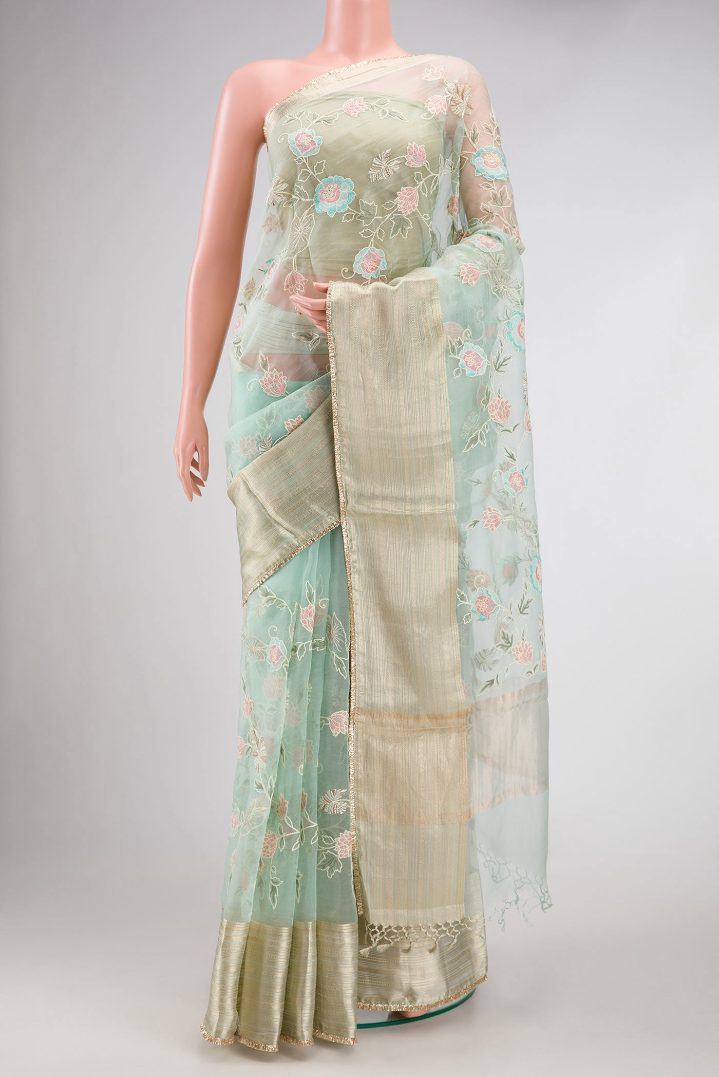 Light Green Dual Tone Organza Silk Saree with Embroidery on the body and Zari Border.  displayed on a mannequin