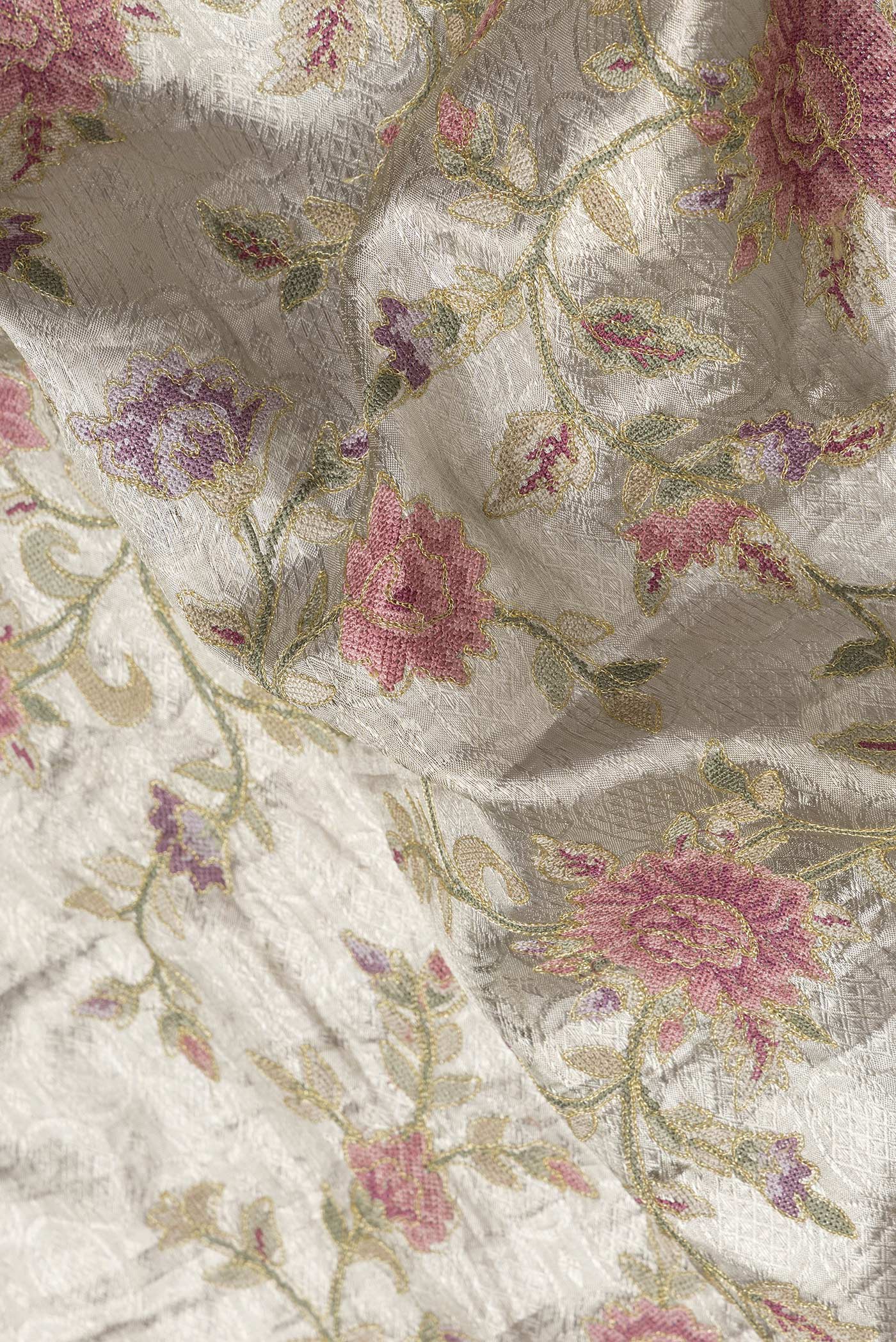 Close up of Gold Dual Tone Organza Silk Saree with Zari Brocade on the body and Zari Border.  displaying folds