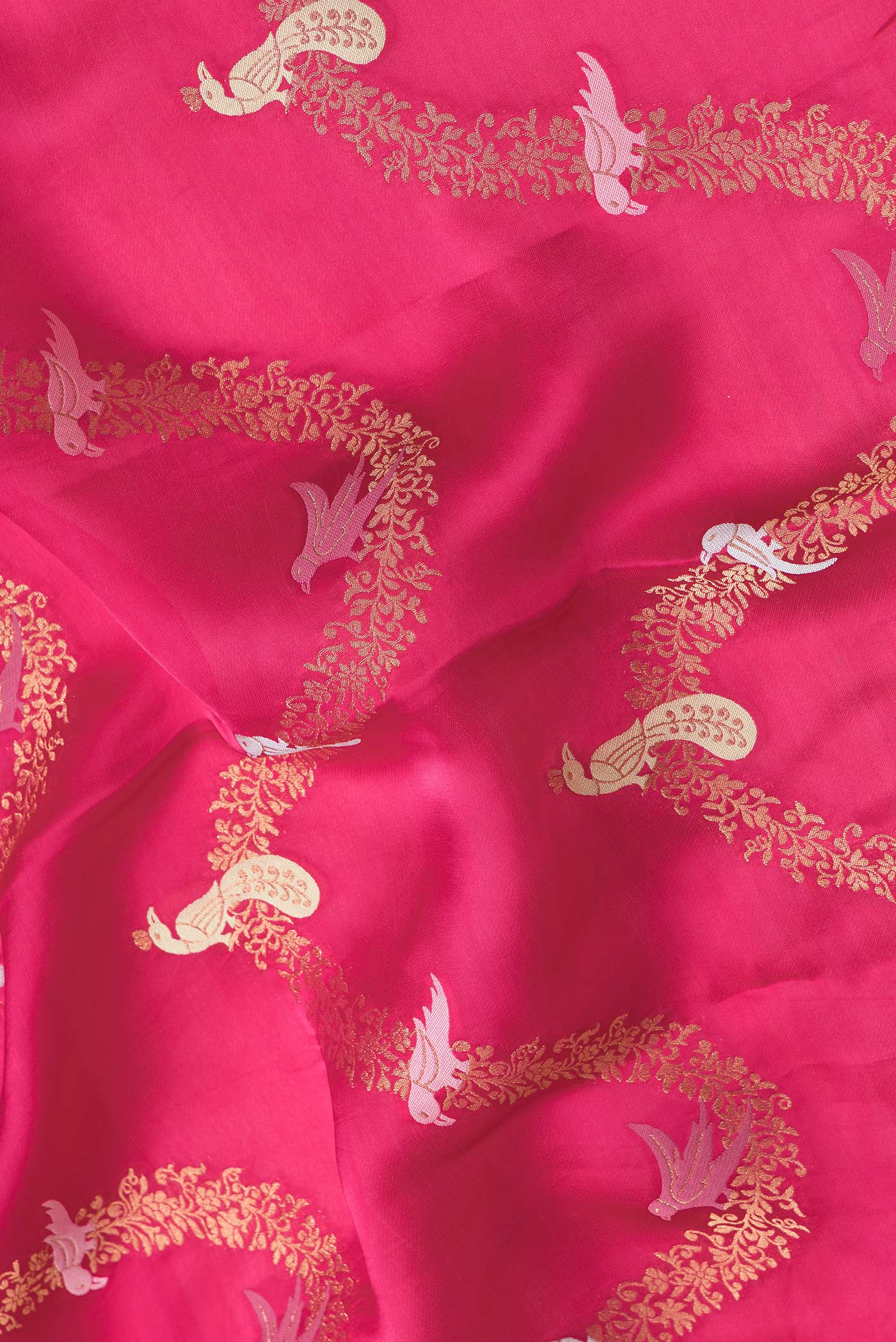 Close up of Pink Dual Tone Banarasi Georgette Saree with Zari Brocade on the body and Embroidery Border.  displaying folds