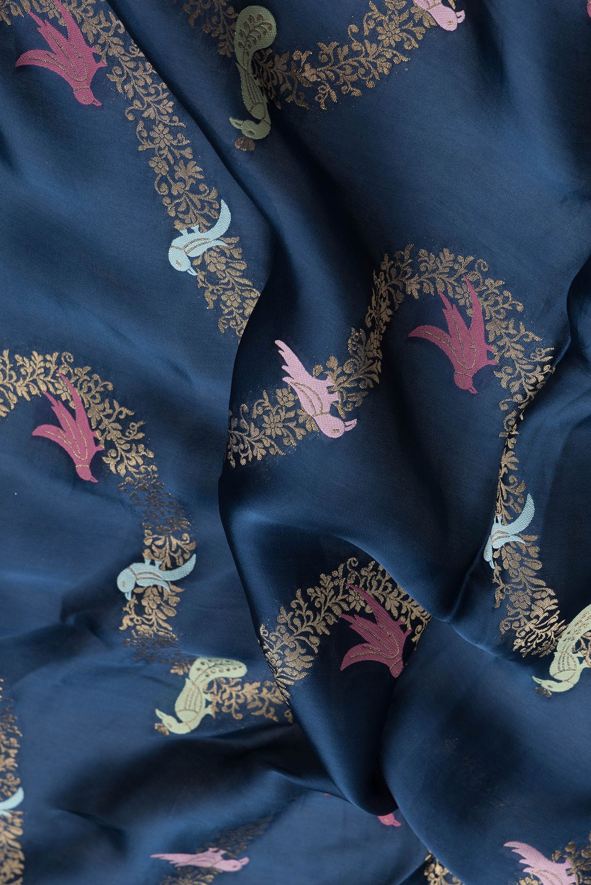 Close up of Navy Blue Dual Tone Satin Crepe Saree with Embroidery on the body and Embroidery Border.  displaying folds