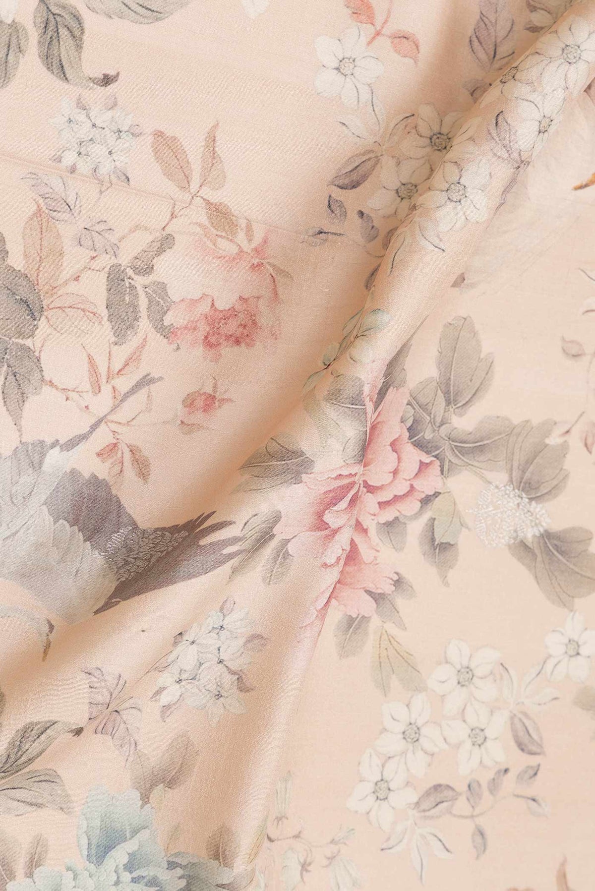 Close up of Peach Dual Tone Tussar Saree with Zari Butta on the body and Zari Border.  displaying folds