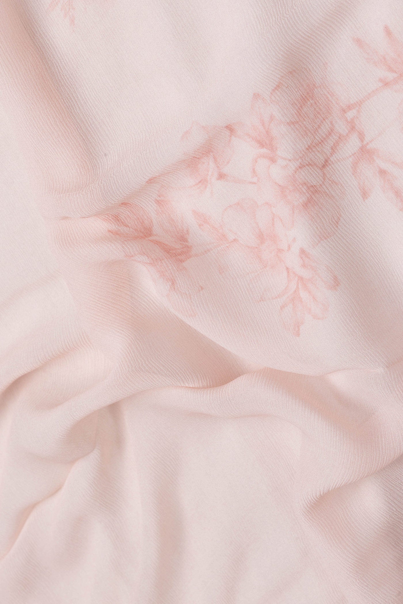 Close up of Peach Dual Tone Mysore Chiffon Saree with Printed design on the body and Zari Border.  displaying folds