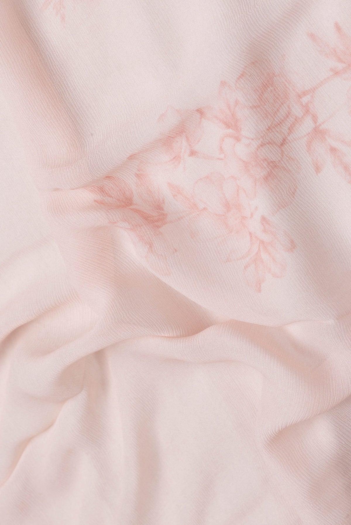 Close up of Peach Dual Tone Mysore Chiffon Saree with Printed design on the body and Zari Border.  displaying folds