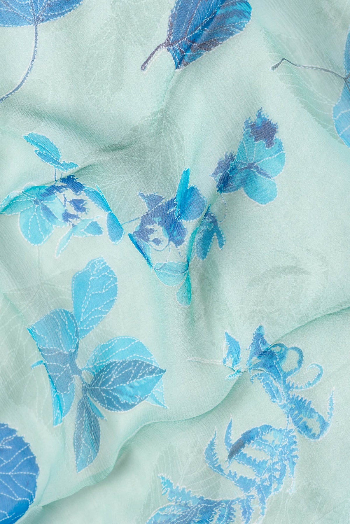 Close up of Sea Green Dual Tone Mysore Chiffon Saree with Printed design on the body and Zari Border.  displaying folds