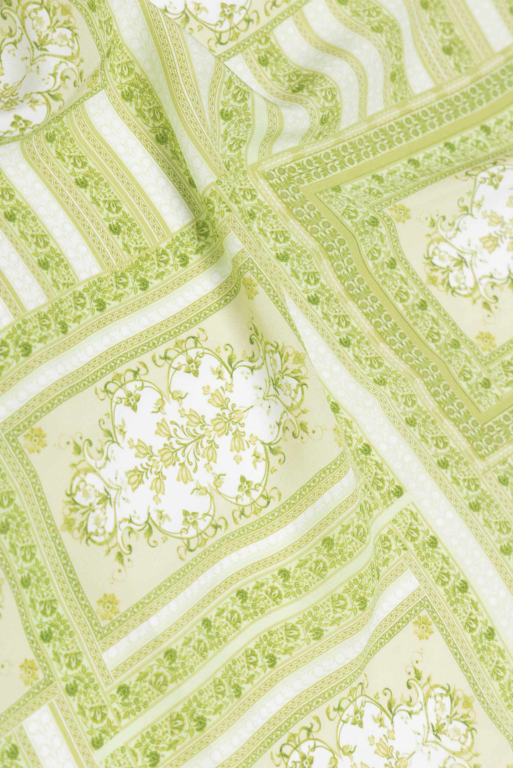 Close up of Pista Green Dual Tone Mysore Crepe Saree with Printed design on the body and Printed Border displaying folds