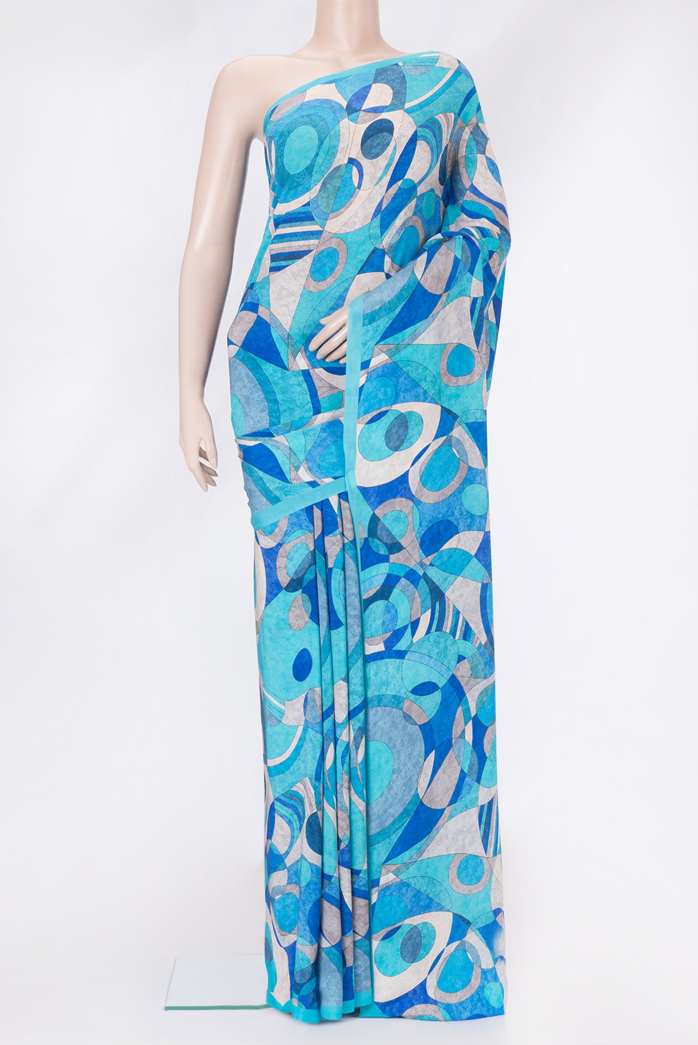 Sky Blue Dual Tone Mysore Crepe Saree with Printed design on the body and Plain Border.  displayed on a mannequin