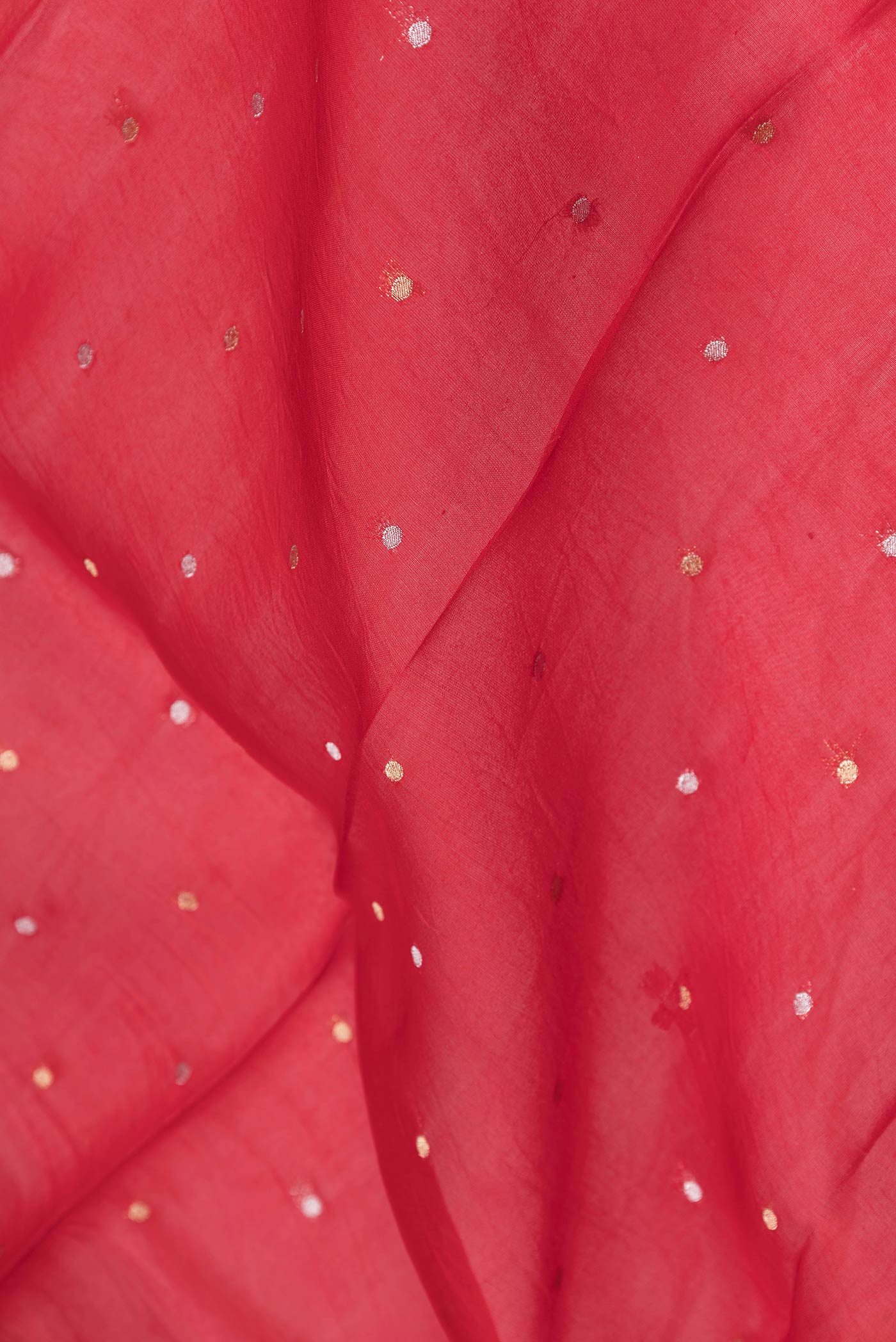 Close up of Red Dual Tone Organza Silk Saree with Embroidery on the body and Zari Border.  displaying folds