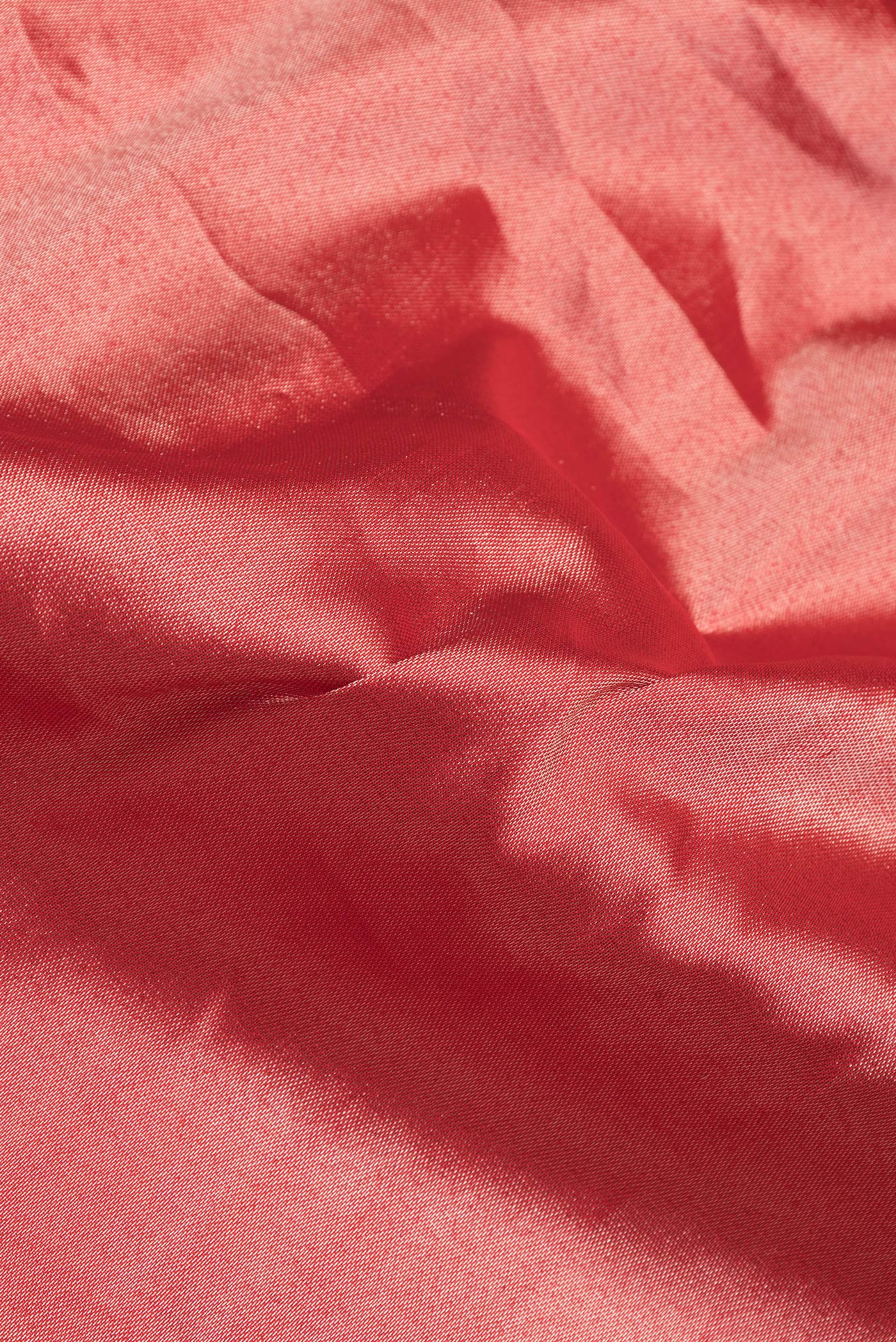 Close up of Red Dual Tone Banarasi Silk Saree with Zari Brocade on the body and Zari Border.  displaying folds