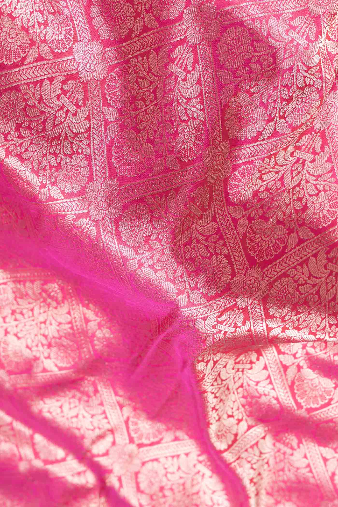 Close up of Pink Dual Tone Banarasi Silk Saree with Zari Brocade on the body and Zari Border.  displaying folds