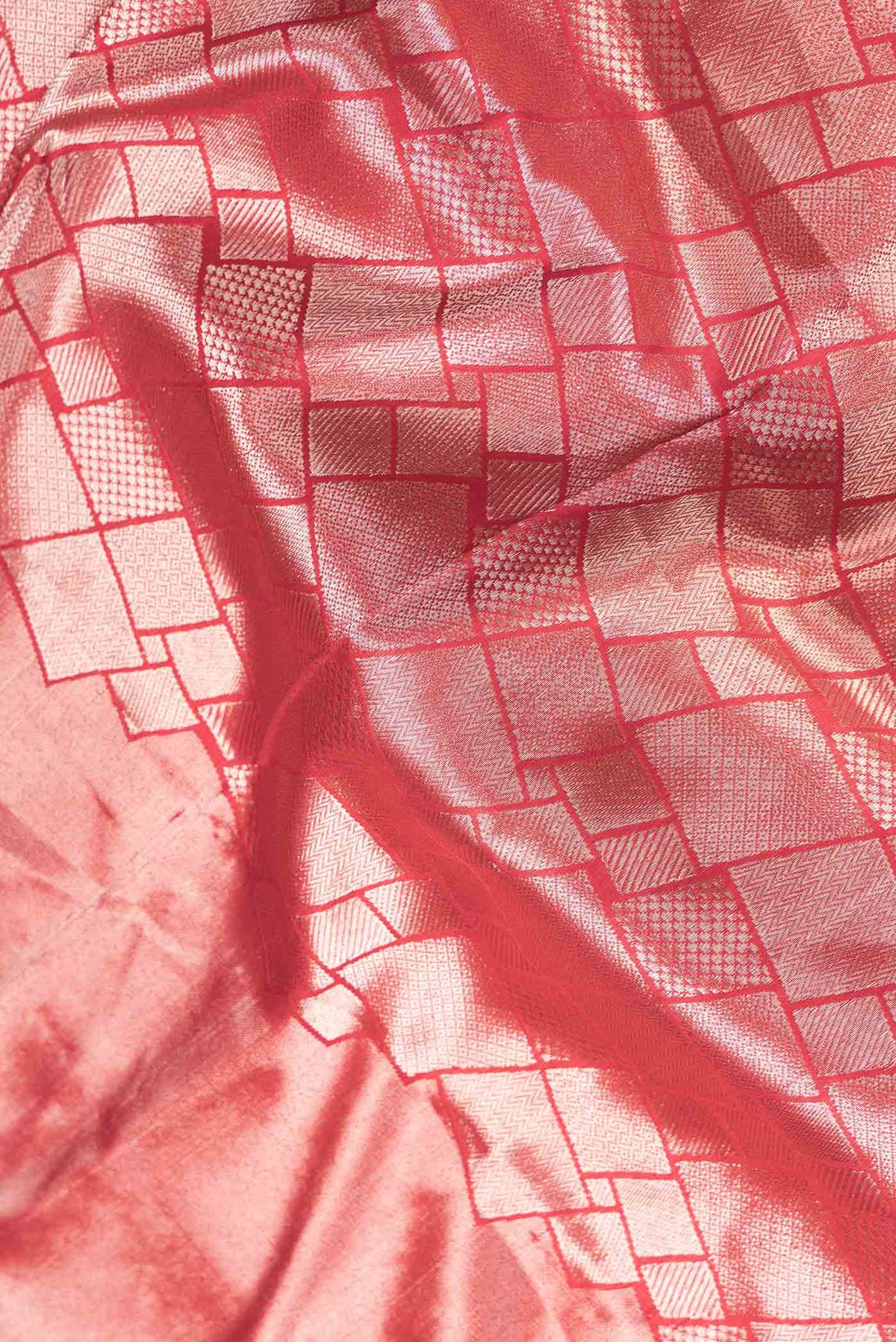 Close up of Red Dual Tone Banarasi Silk Saree with Zari Brocade on the body and Zari Border.  displaying folds