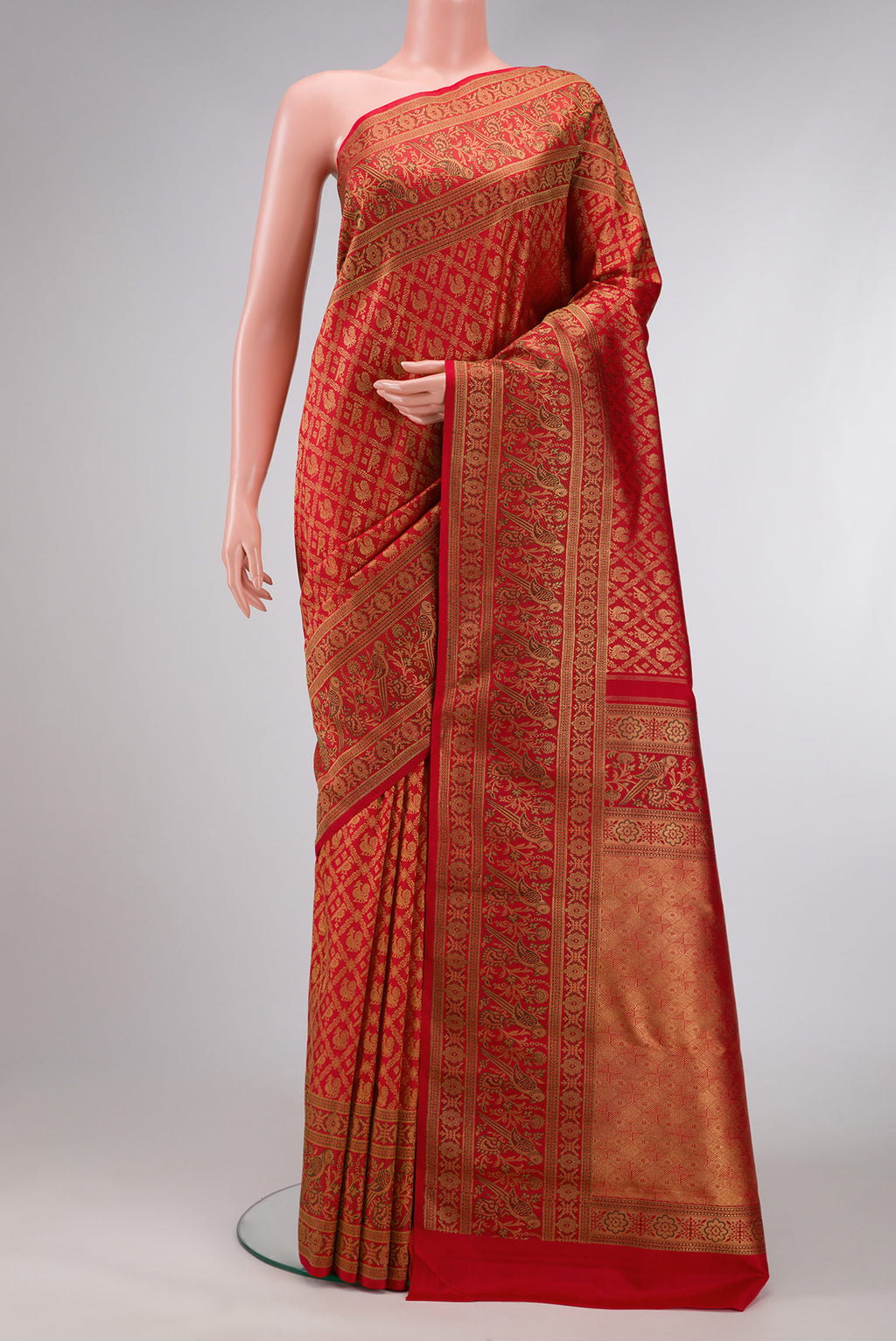 Pure Silk Pure Zari Red Dual Tone Kanjivaram Saree with Zari Brocade on the body and Zari Border.  displayed on a mannequin